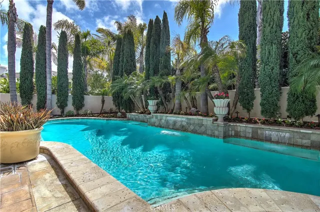 a kitchen with stainless steel appliances granite countertop a sink a stove and a wooden floors