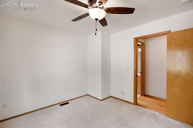 398 Pinewood Road Florissant, CO 80816 - Photo 18 of 43 Main level bedroom featuring ceiling fan