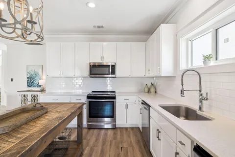 a view of a livingroom with furniture wooden floor and a window