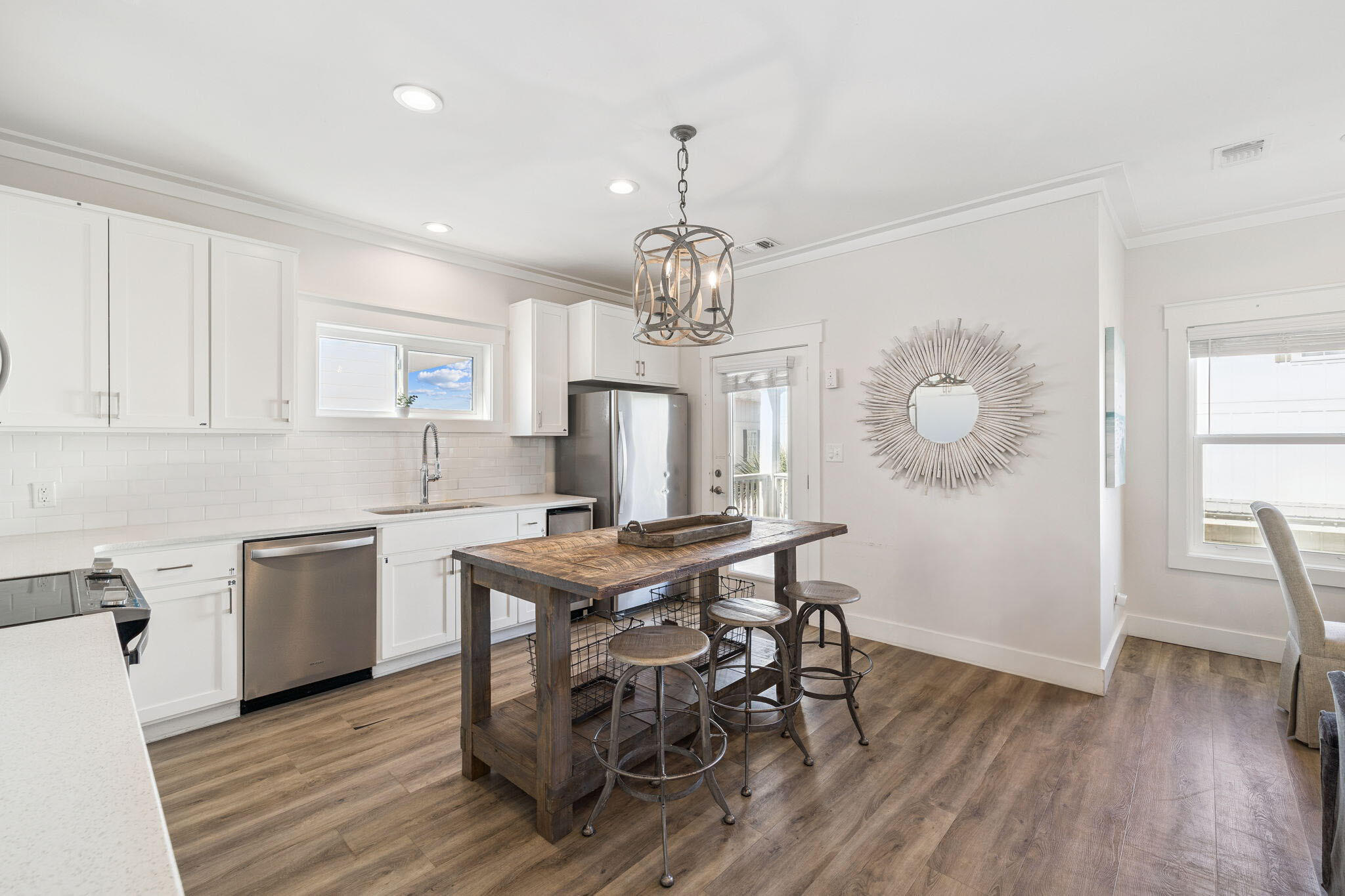 10 Blue Surf Lane Miramar Beach, FL 32550 - Photo 15 of 50 a kitchen with stainless steel appliances granite countertop a kitchen island hardwood floor sink stove dining table and chairs
