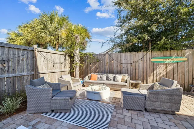 a view of a patio with couches and potted plants