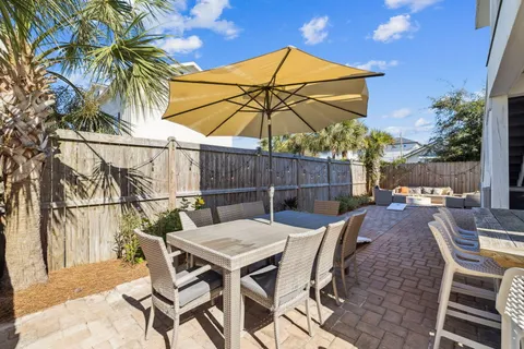 a view of a patio with table and chairs and potted plants