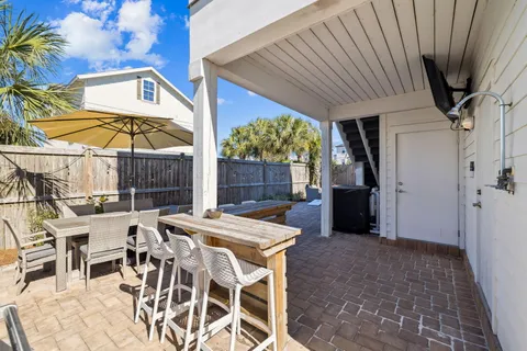 a view of a chairs and tables in the back yard of a house