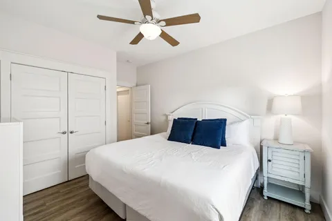 a bedroom with a large bed and a flat screen tv