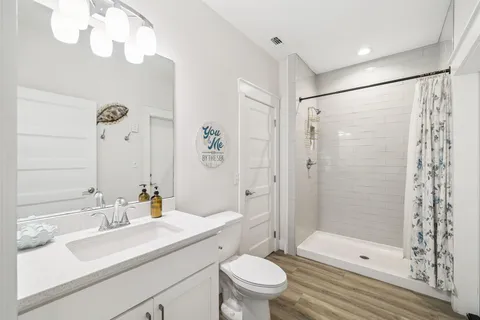 a bedroom with a bed and a flat tv screen on dresser