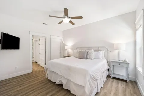 a bedroom with a bed and a flat screen tv