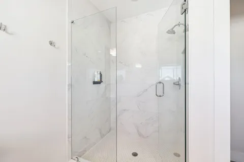 a bathroom with a shower sink and mirror