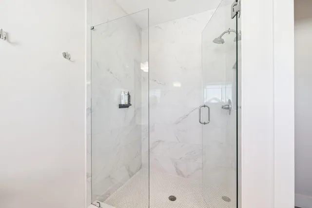 a bathroom with a shower sink and mirror