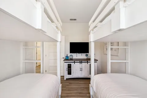 a bedroom with a large bed and a chandelier