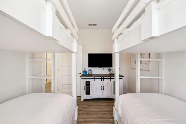 a bedroom with a large bed and a chandelier