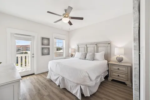 a bedroom with a bed and a flat tv screen on dresser