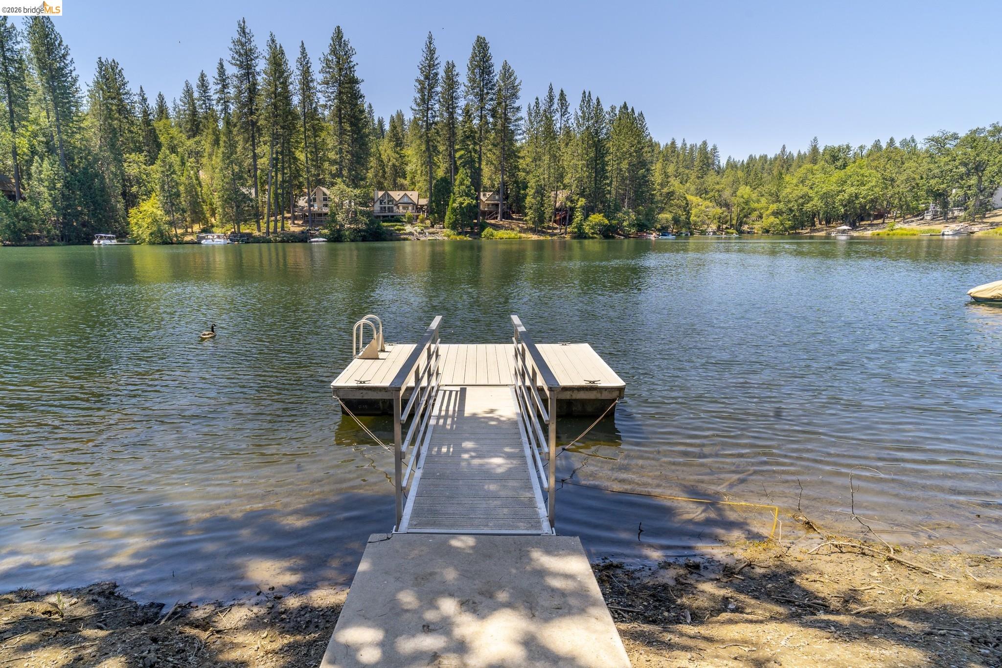 19711 Pleasantview Drive Groveland, CA 95321 - Photo 2 of 39 Private dock with a concrete ramp and wooden platform, offering direct water access