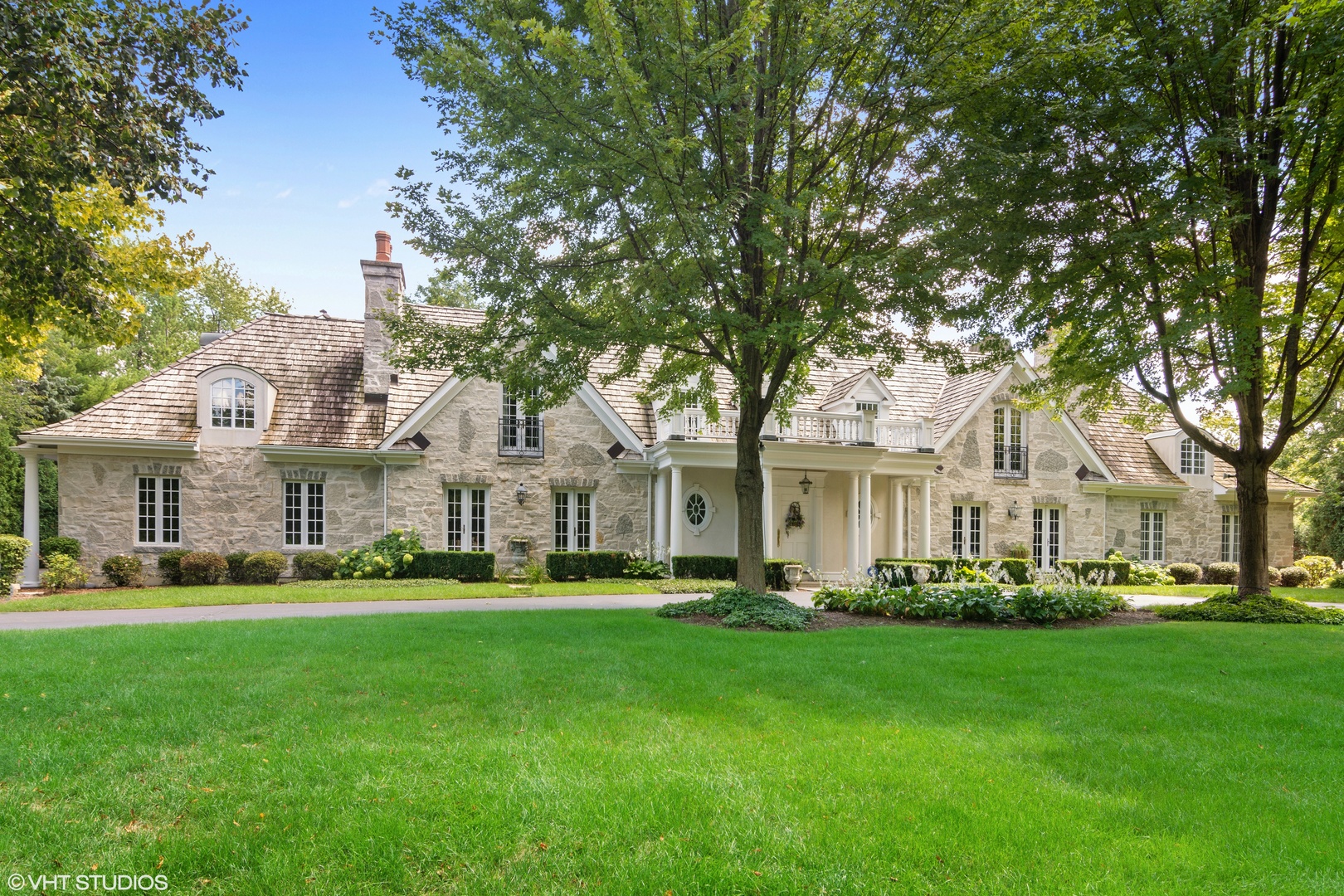 1717 Appleby Road Inverness, IL 60067 - Photo 1 of 57 a front view of a house with a garden and trees