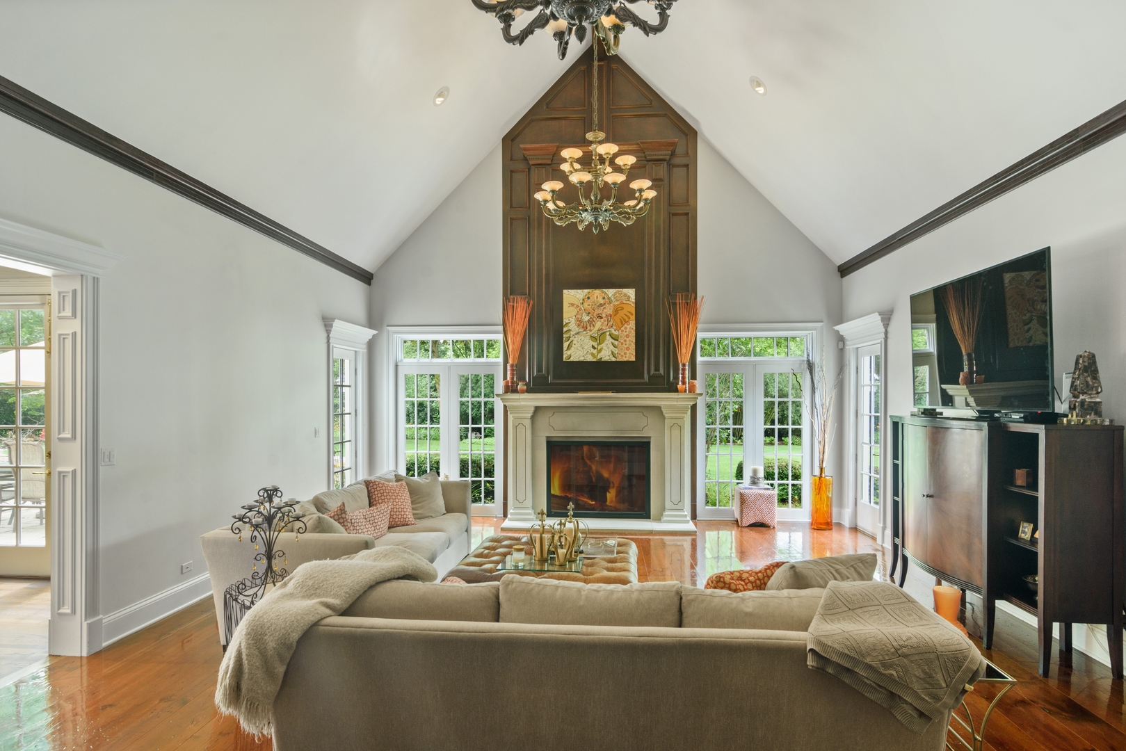 1717 Appleby Road Inverness, IL 60067 - Photo 20 of 57 a living room with furniture a fireplace and a chandelier
