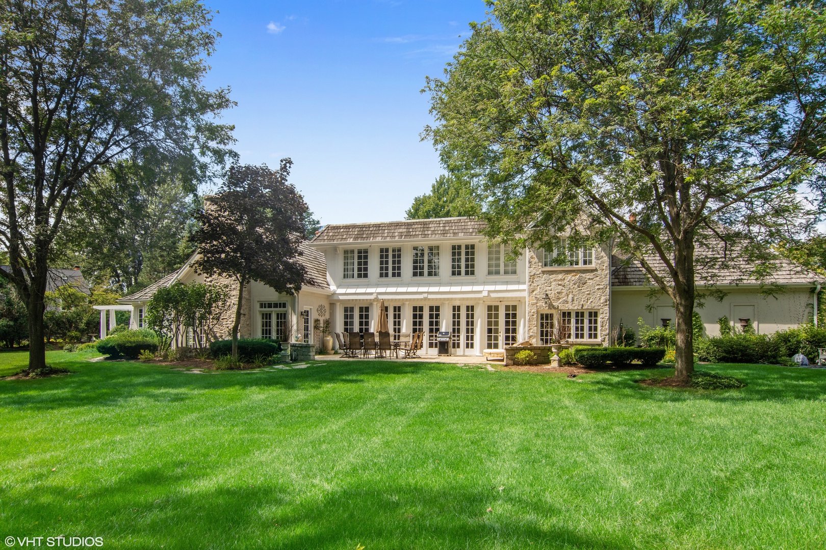 1717 Appleby Road Inverness, IL 60067 - Photo 49 of 57 a front view of a building with a garden and trees