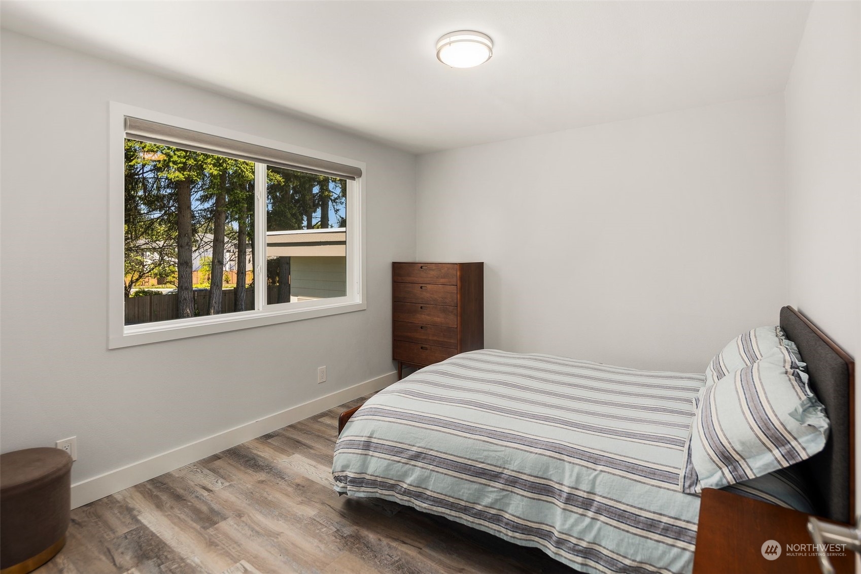 102 Bellflower Road Bothell, WA 98012 - Photo 16 of 40 a bedroom with a bed and wooden floor
