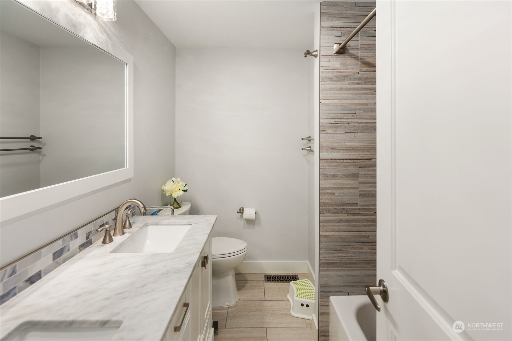 102 Bellflower Road Bothell, WA 98012 - Photo 17 of 40 a bathroom with a granite countertop sink toilet and shower