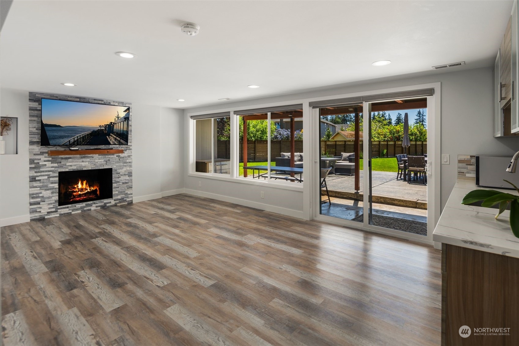 102 Bellflower Road Bothell, WA 98012 - Photo 19 of 40 a view of an empty room with wooden floor and a fireplace