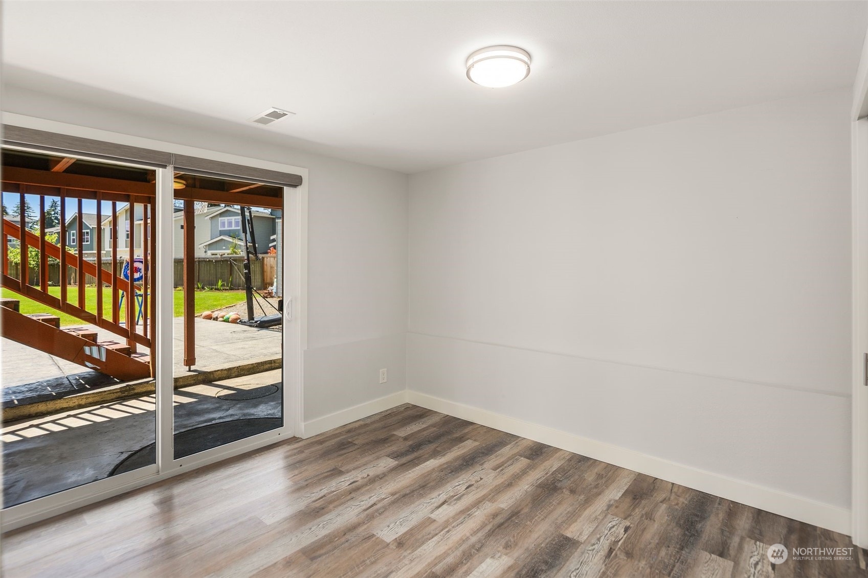 102 Bellflower Road Bothell, WA 98012 - Photo 24 of 40 an empty room with wooden floor and windows