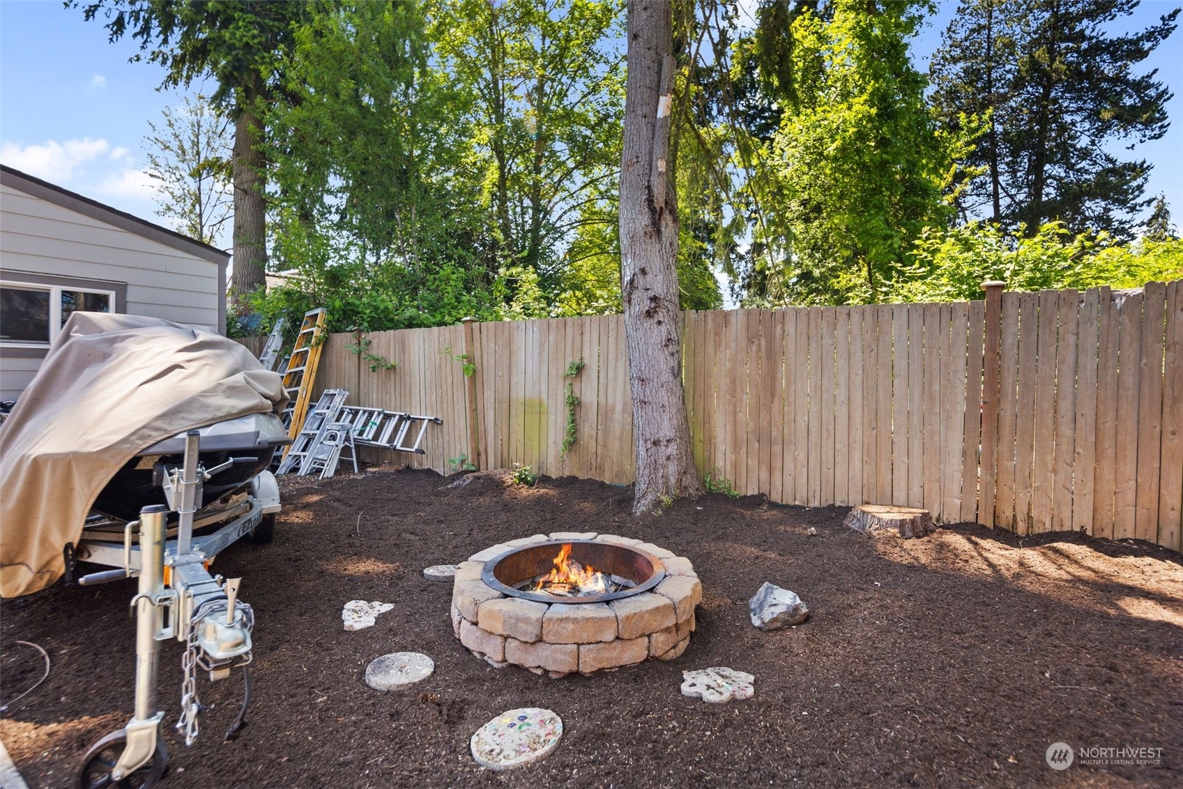102 Bellflower Road Bothell, WA 98012 - Photo 30 of 40 a view of a backyard with table and chairs and a fire pit