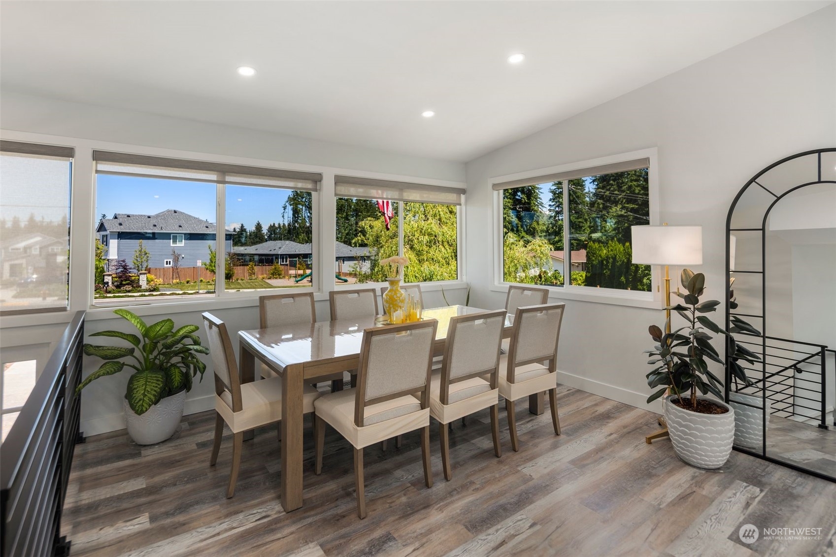 102 Bellflower Road Bothell, WA 98012 - Photo 4 of 40 a dining room with furniture a potted plant and wooden floor