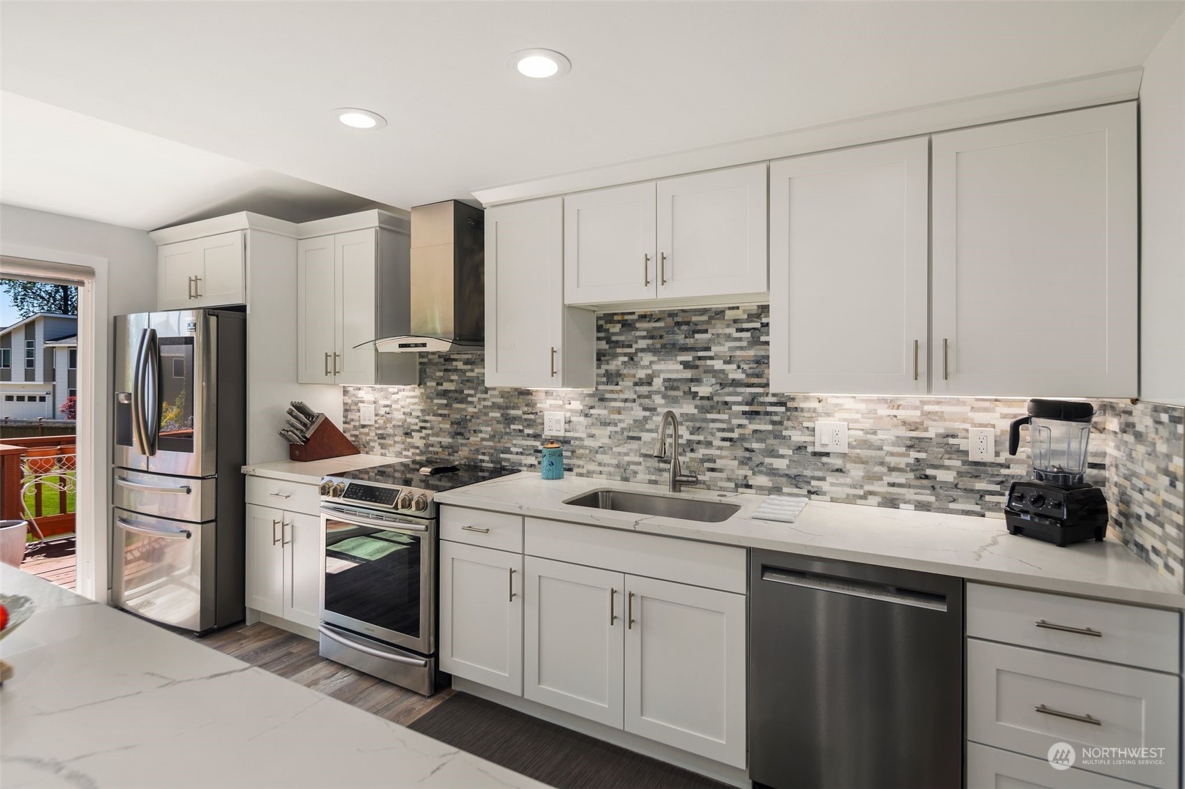 102 Bellflower Road Bothell, WA 98012 - Photo 6 of 40 a kitchen with stainless steel appliances white cabinets and a sink
