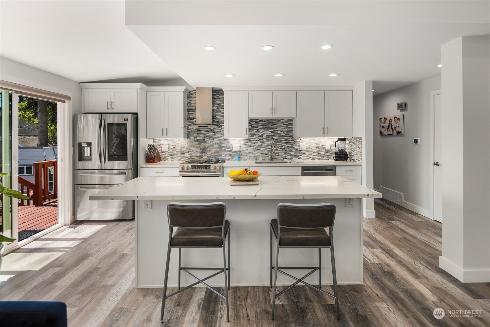102 Bellflower Road Bothell, WA 98012 - Photo 7 of 40 a kitchen with stainless steel appliances a dining table chairs and wooden floor
