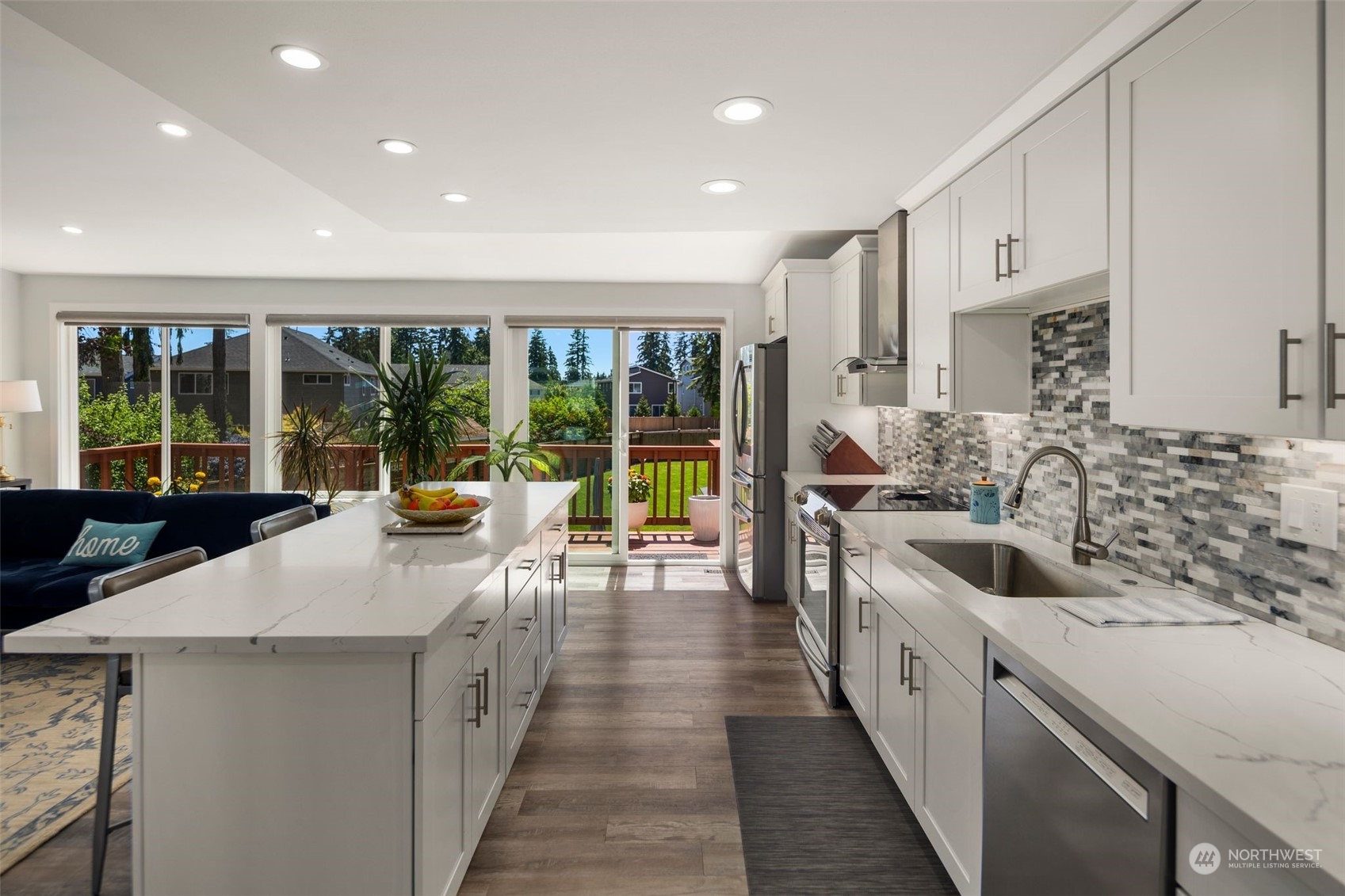 102 Bellflower Road Bothell, WA 98012 - Photo 8 of 40 a kitchen with stainless steel appliances a sink stove and cabinets