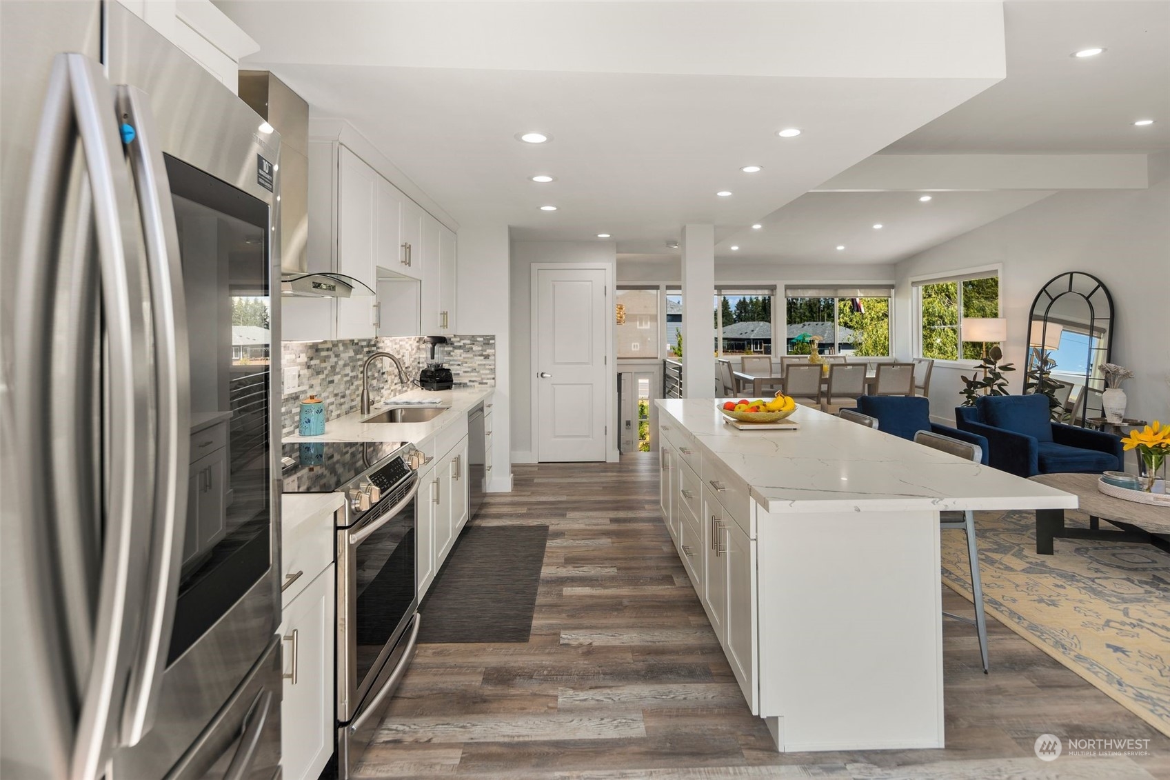 102 Bellflower Road Bothell, WA 98012 - Photo 9 of 40 a kitchen with stainless steel appliances a white stove top oven a sink a refrigerator and white cabinets