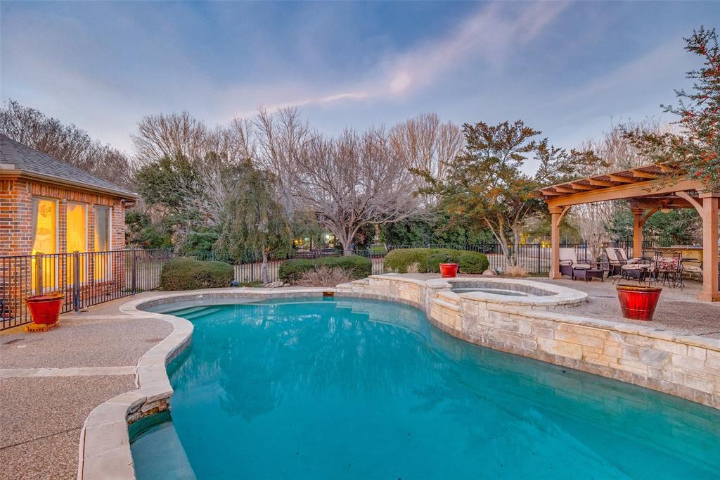 390 Oak Ridge Drive Fairview, TX 75069 - Photo 8 of 12 a view of a swimming pool with a patio and a yard