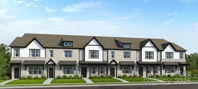 a front view of a residential apartment building with a yard