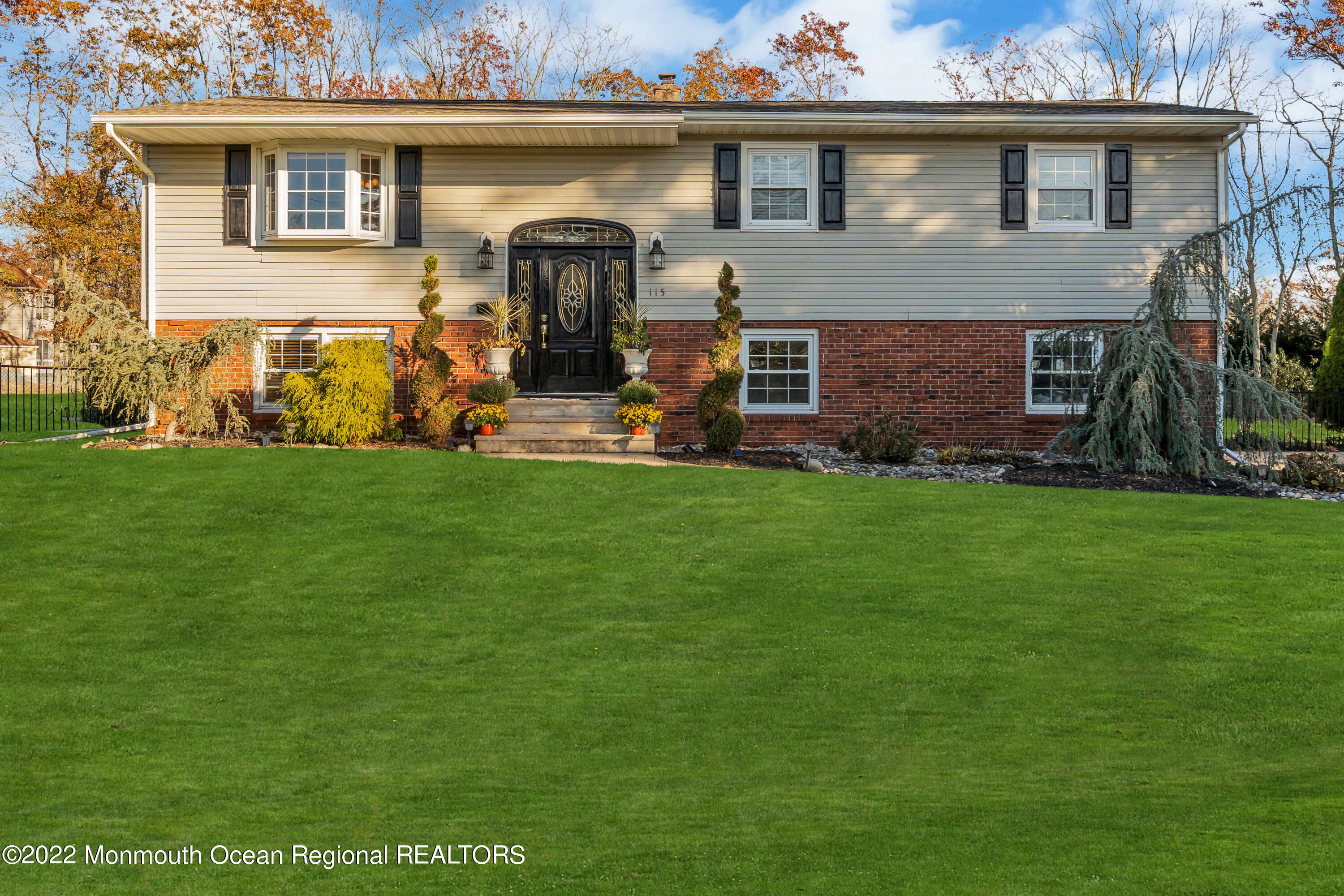 a front view of a house with a garden