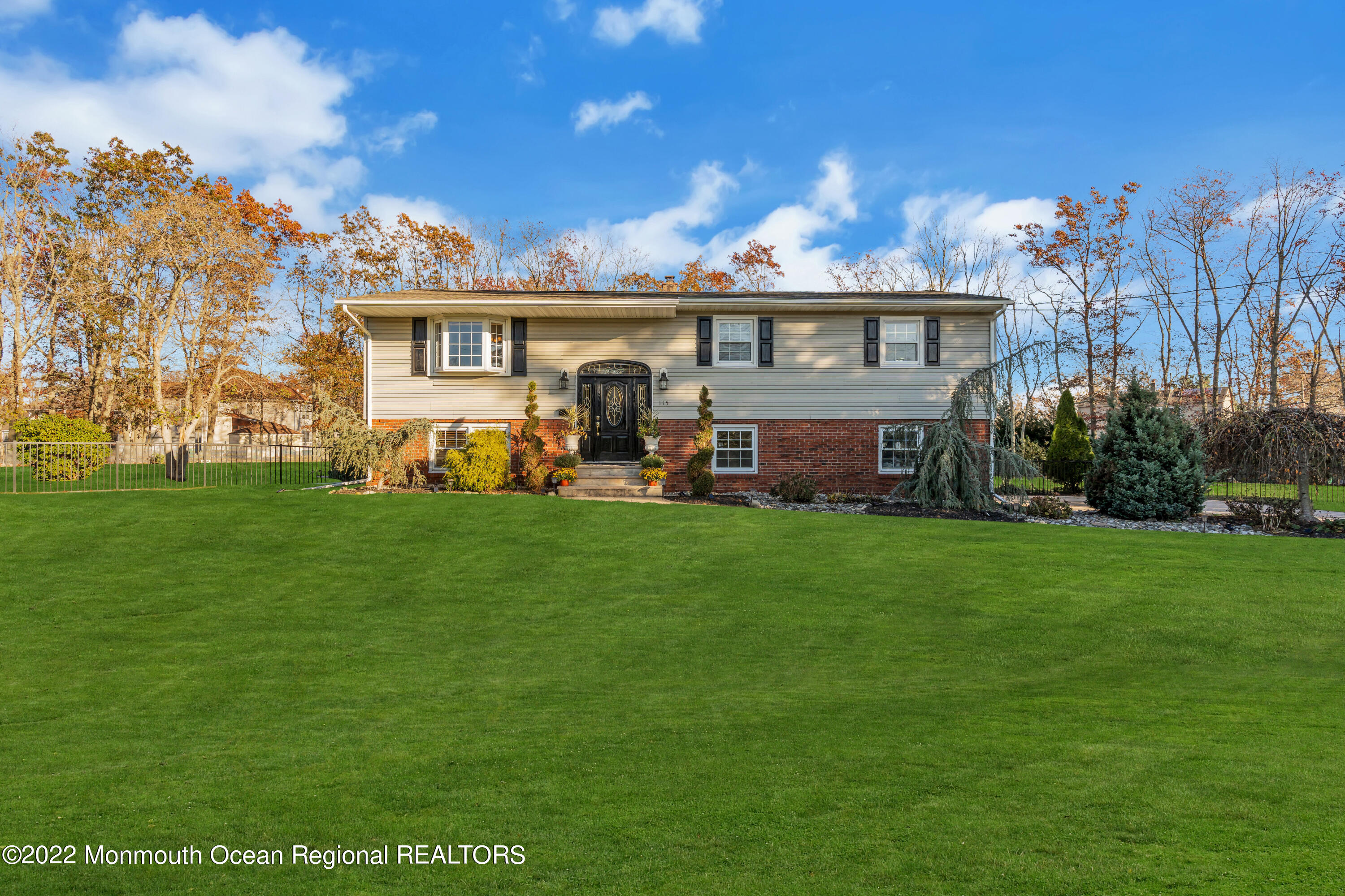 115 Greymoor Road Howell, NJ 07731 - Photo 38 of 38 a front view of a house with a garden and plants