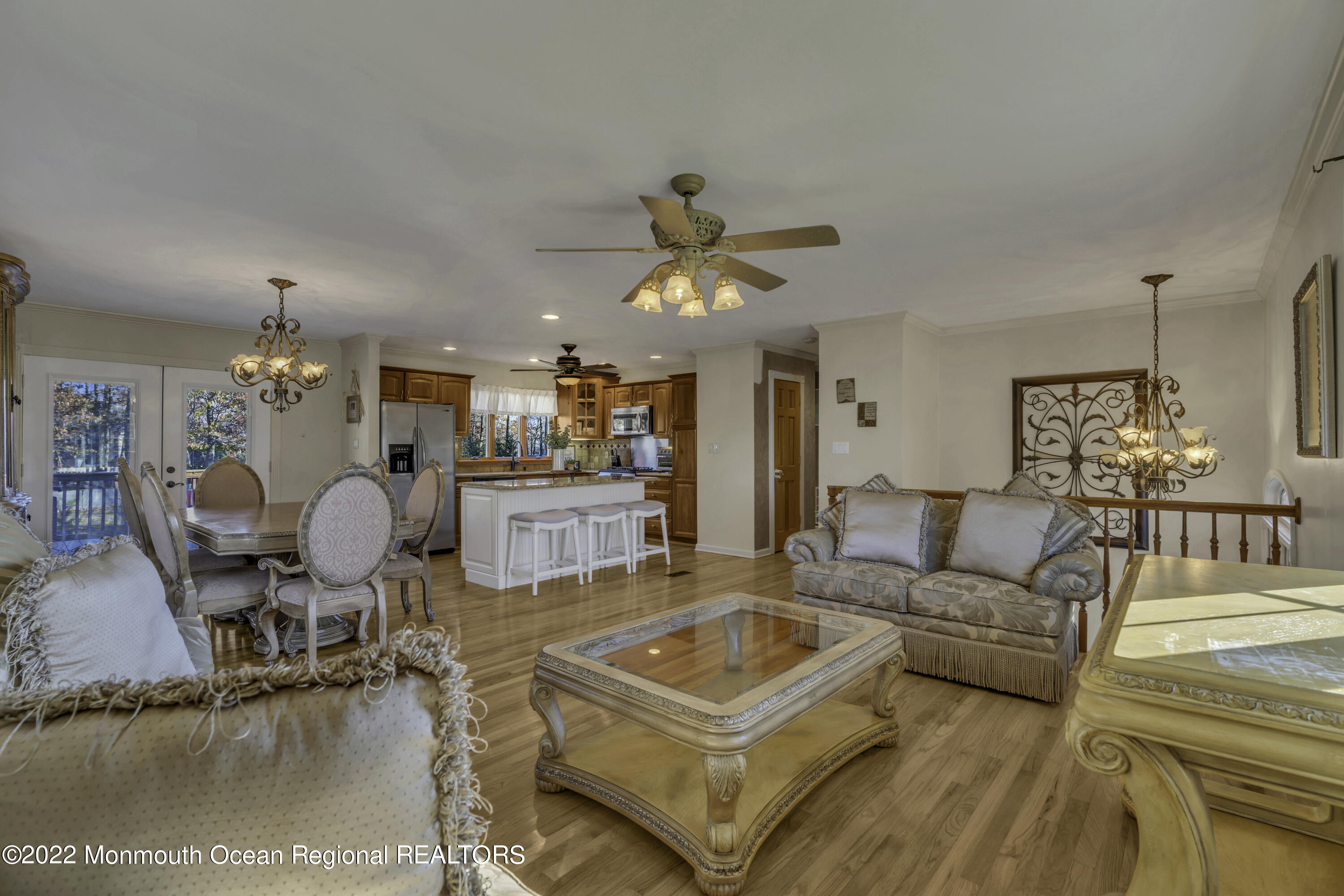 115 Greymoor Road Howell, NJ 07731 - Photo 9 of 38 a living room with furniture a dining table and a chandelier