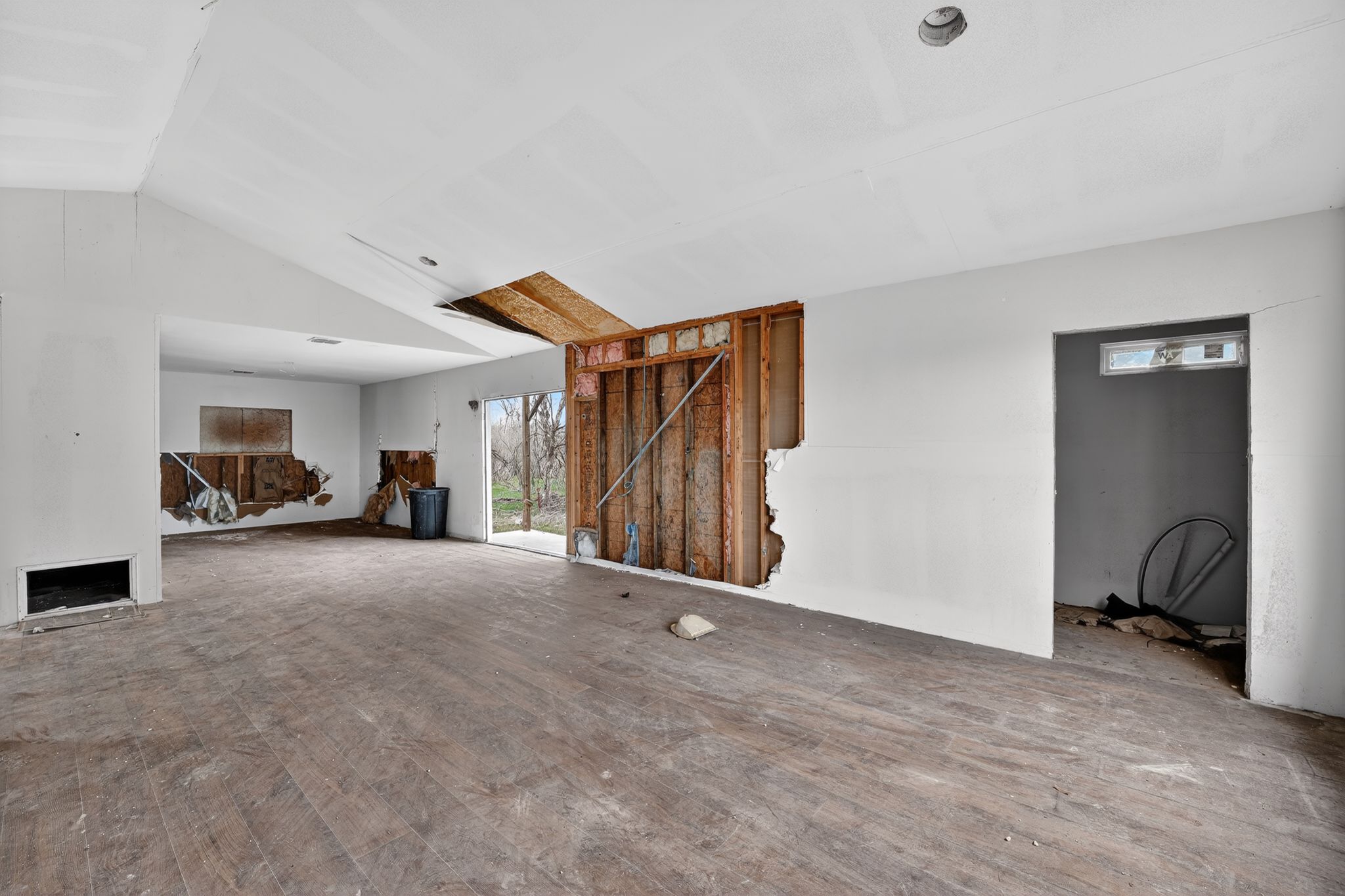 11223 Tom Sassman Road Austin, TX 78747 - Photo 37 of 40 Unfurnished living room featuring vaulted ceiling and wood finished floors