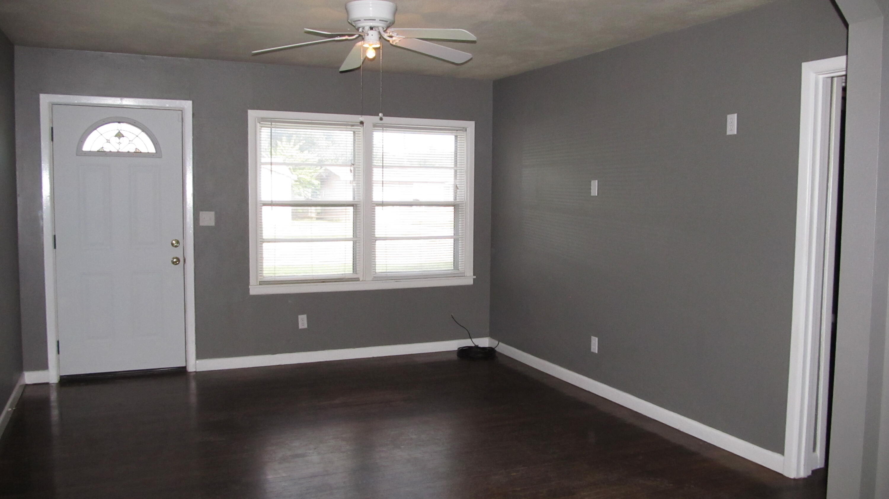 2013 48th Street Lubbock, TX 79412 - Photo 3 of 7 a view of an empty room with wooden floor and a window