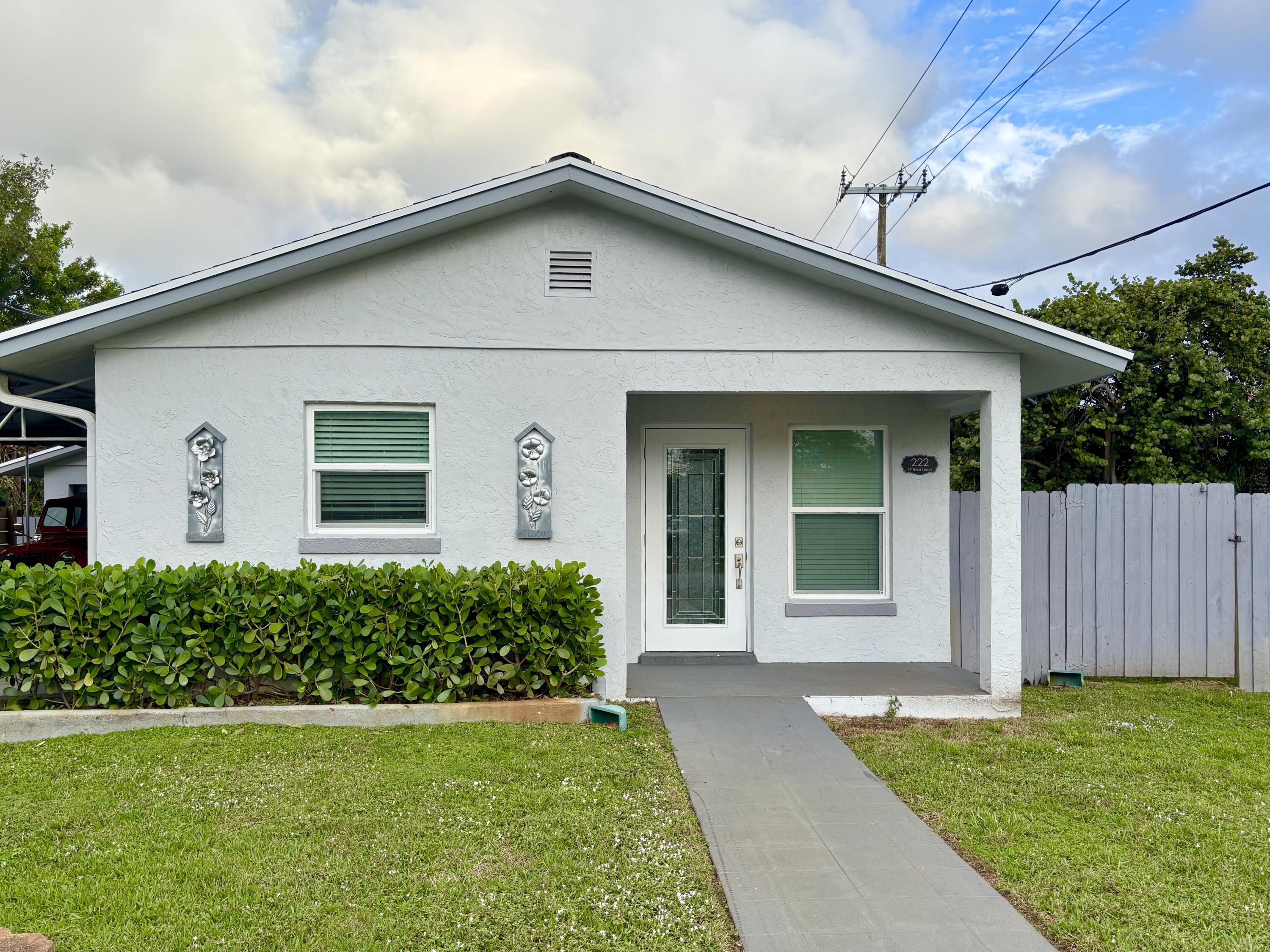 222 Southeast 3rd Street Boynton Beach, FL 33435 - Photo 1 of 40 a front view of a house with a yard