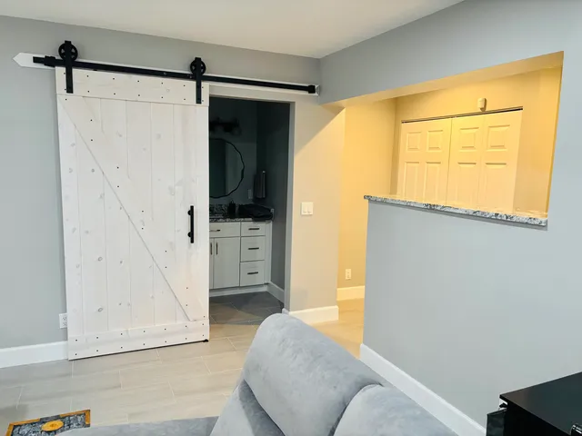 a living room with a couch and a walk in closet