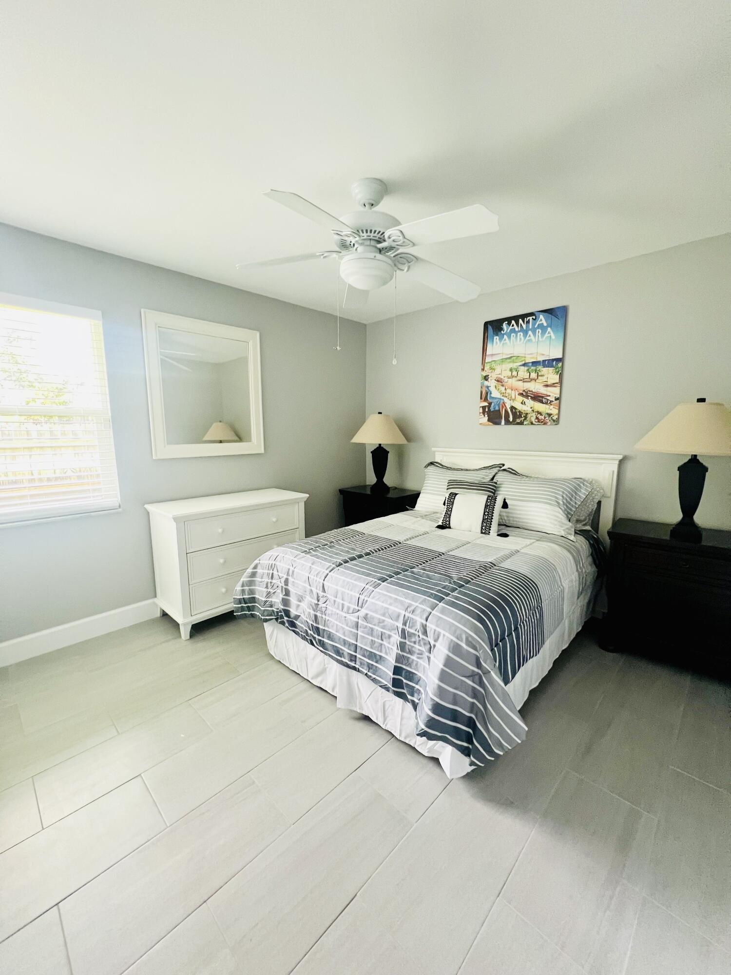 222 Southeast 3rd Street Boynton Beach, FL 33435 - Photo 18 of 40 a bedroom with a bed and a window