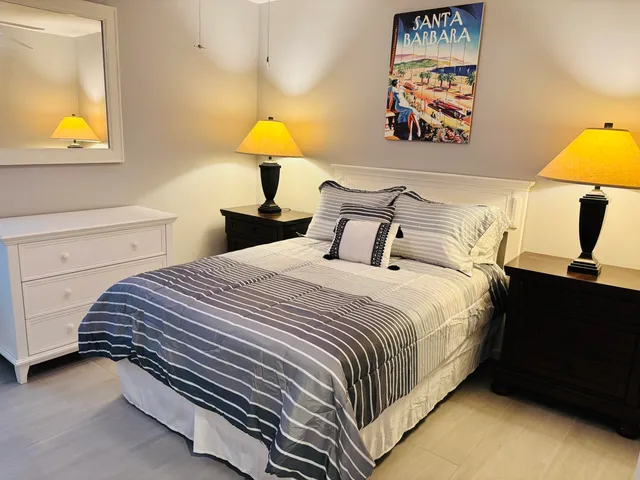 a bedroom with a bed and a lamp on table