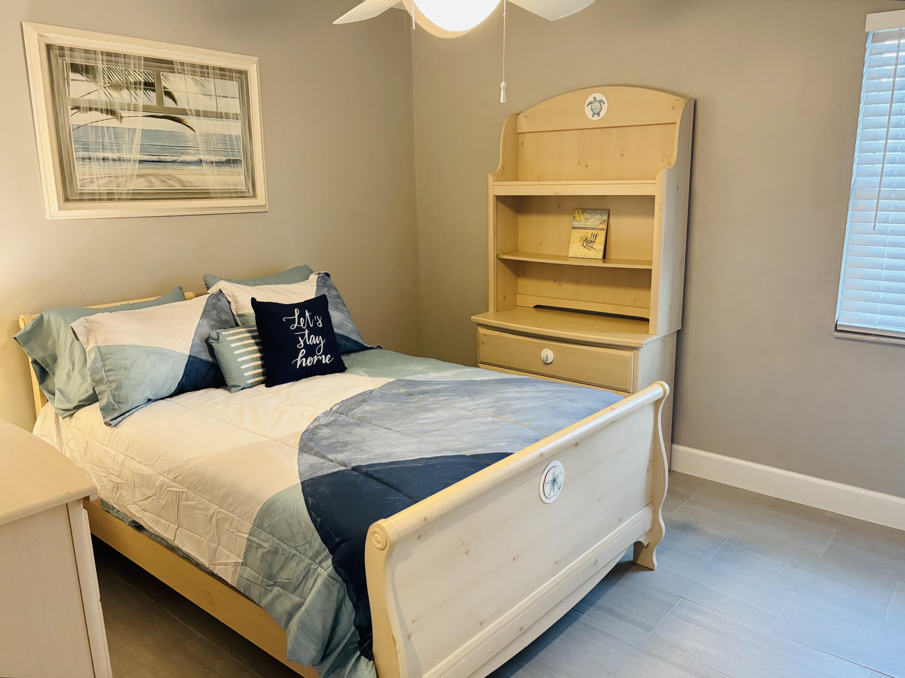 222 Southeast 3rd Street Boynton Beach, FL 33435 - Photo 20 of 40 a bedroom with a bed and wooden floor