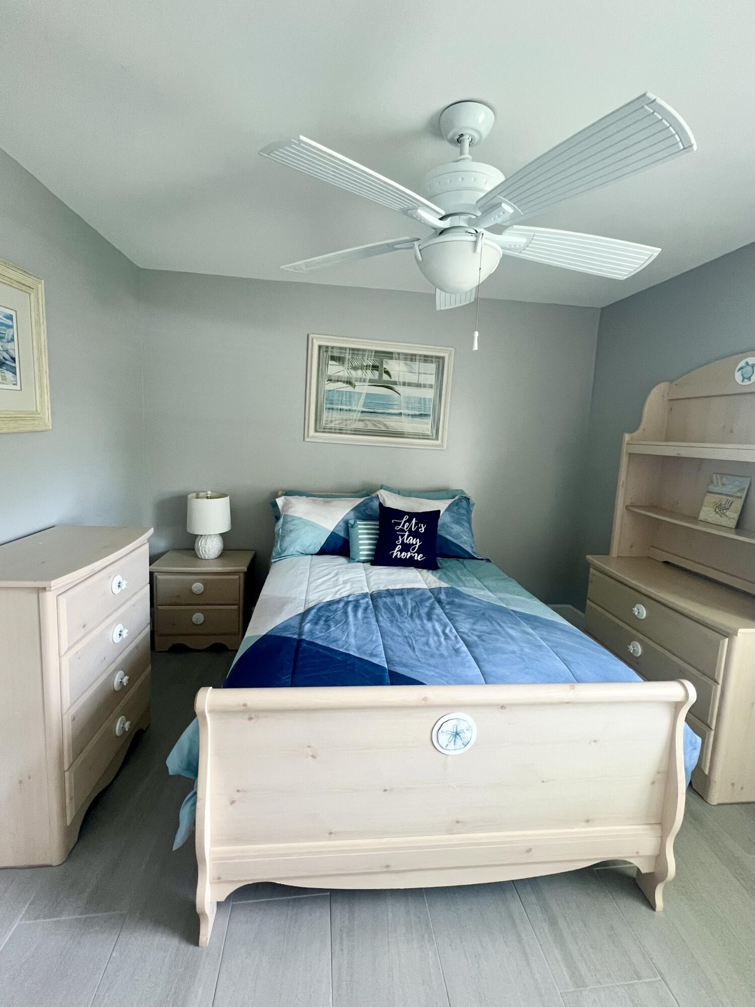 222 Southeast 3rd Street Boynton Beach, FL 33435 - Photo 21 of 40 a bedroom with a bed and a chandelier