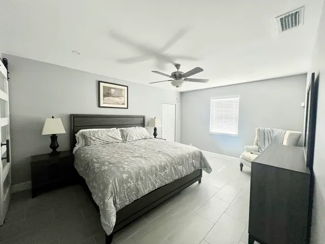 a bedroom with a bed and window