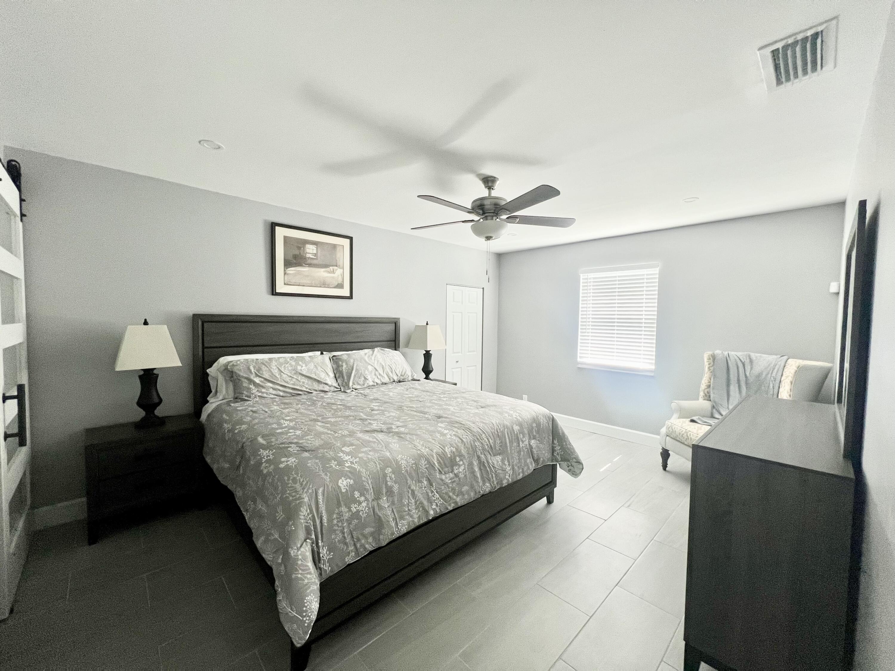 222 Southeast 3rd Street Boynton Beach, FL 33435 - Photo 22 of 40 a bedroom with a bed and window