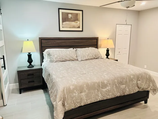 a bed sitting in a bedroom and painting on the wall