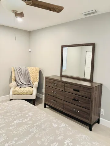 a living room with furniture and a dresser