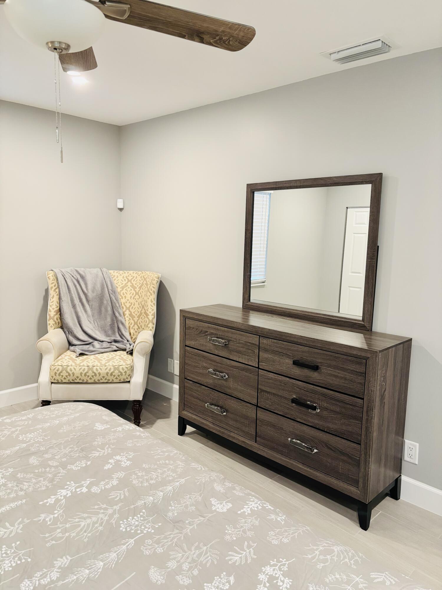 222 Southeast 3rd Street Boynton Beach, FL 33435 - Photo 24 of 40 a living room with furniture and a dresser