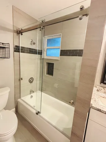 a bathroom with a bathtub and a shower
