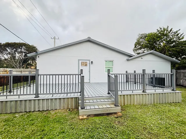 a view of a house with a wooden deck