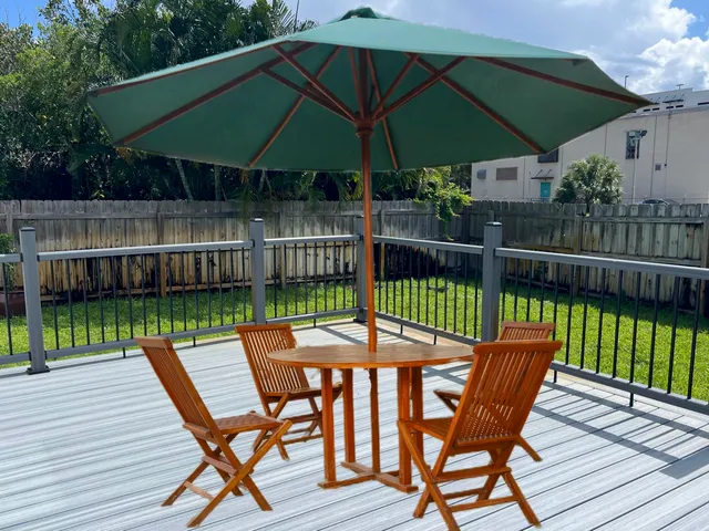 a view of a chair and table on the deck in the patio